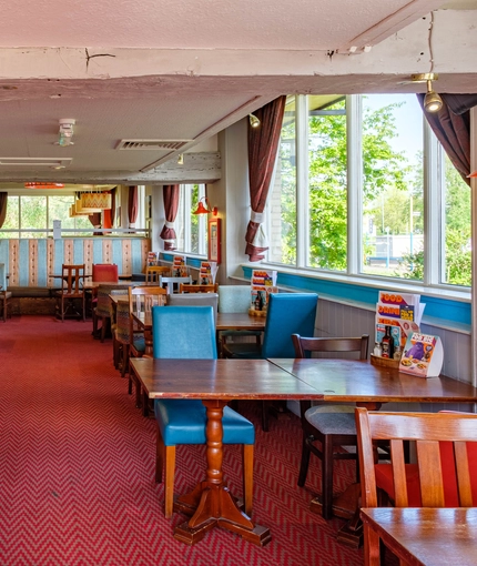 Interior dining area of a pub with candy machines.