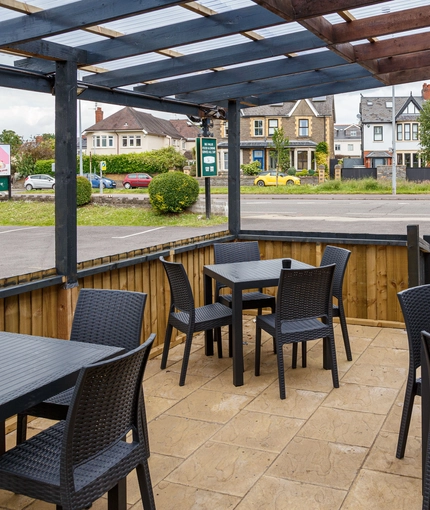 Exterior beer garden of a pub with a seating area.