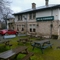 Exterior facade and beer garden of a pub with a seating area.