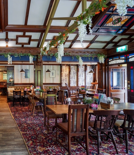 Interior dining area of a pub with a bar.