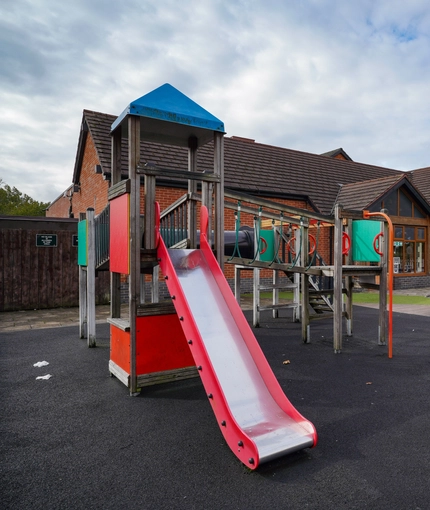 exterior beer garden of a pub with a seating area and a play area