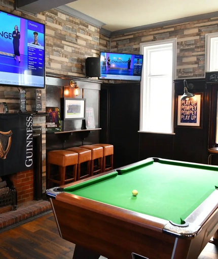 interior seating area with tv and pool table