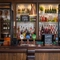 A close up view of the bar inside The Man On The Moon, showing the beer taps, bottles of various wines and spirits on shelves, and glasses hanging in racks above the bar.