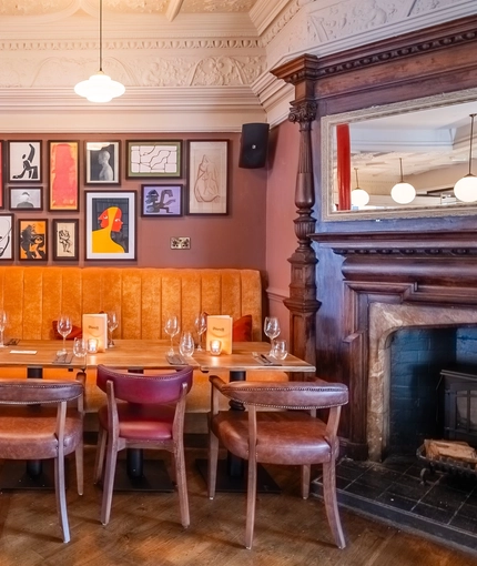 The interior restaurant seating area with feature fireplace at The Durell Arms.