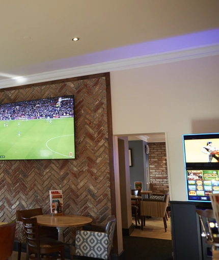 The interior restaurant and seating area with TV at the Snipe.