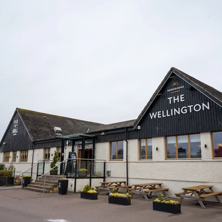 The exterior facade and seating area at The Wellington Hotel.