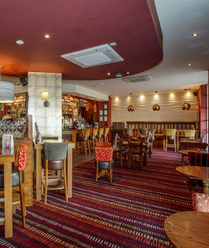 Interior dining area of a pub with a bar.