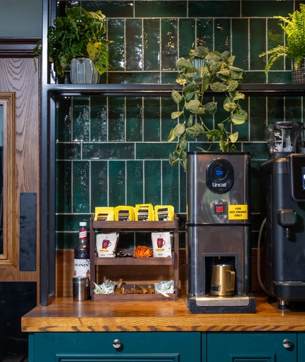 The interior hot drinks station with potted plant decor at The Church View Inn.