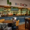The bar and interior restaurant seating area at The Kittoch, with a TV on the wall.