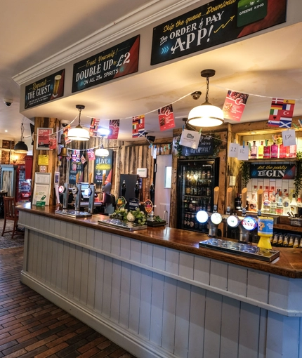Interior dining area of a pub with a bar.