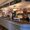 Interior dining area of a pub with a bar.