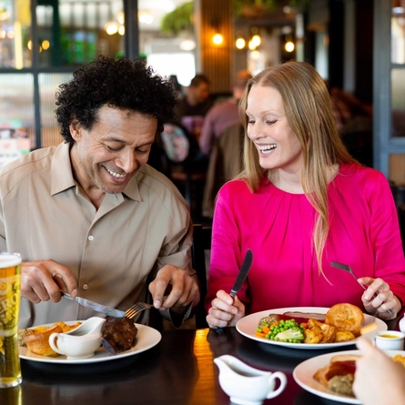A family enjoying a meal and drinks in the interior restaurant from the new Spring/Summer menu at Flaming Grill.