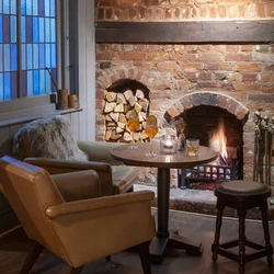 An armchair by the fireplace in the Roebuck