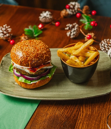 A Festive main of Camembert Cranberry Falafel Burger served in the restaurant at a Community Food venue.