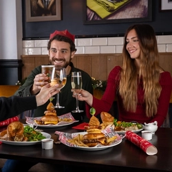 a group of people eating at a table of a pub