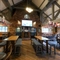 Interior dining area of a pub with a fireplace and a TV.