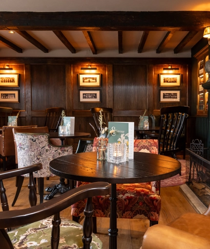Some tables in the restaurant of the Grapes.