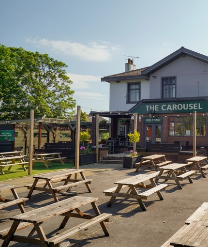Exterior facade of a pub with a seating area.