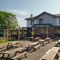 Exterior facade of a pub with a seating area.