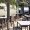 The exterior undercover seating area at The Carousel, with hanging flower baskets and string lights.