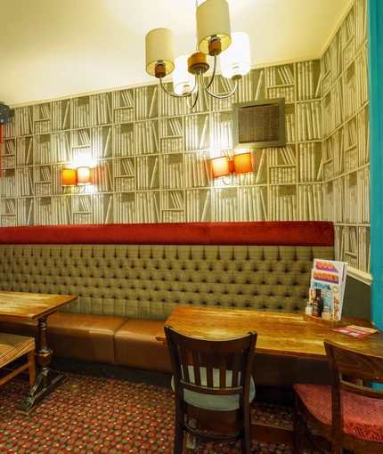 Interior dining area of a pub with a TV.