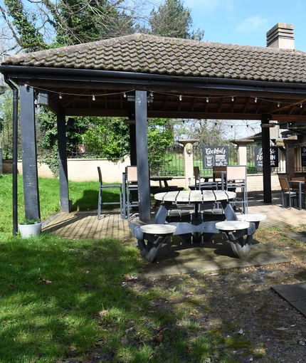 Exterior beer garden of a pub with a seating area.