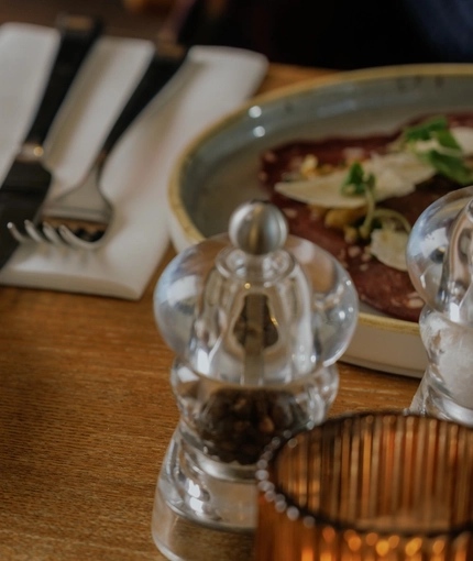 An advertising image of a plated starter dish from the Burns Night menu sat on a table within the interior restaurant seating area at The Crown.