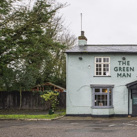 An image showing the exterior facade, venue signage and car park at The Green Man.