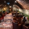 The interior restaurant seating area with tables, chairs, arched brick ceiling and tiled flooring at The Watergates Bar.