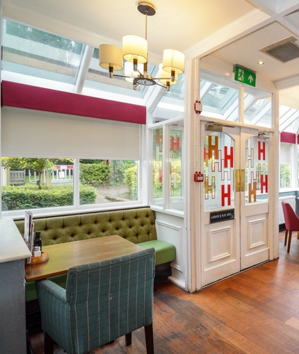 Interior dining area of a pub with claw machines.