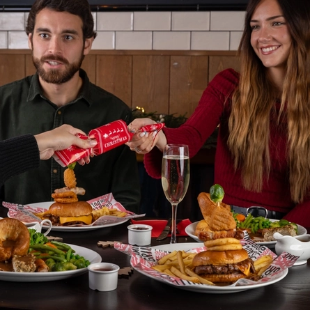 a group of people eating at a table of a pub