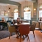 The interior restaurant seating area with TV at The Greengage.
