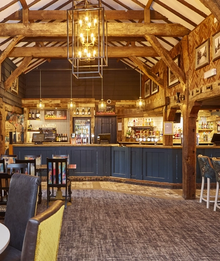 The interior restaurant and seating area with TV and bar at the Rovers Tye.