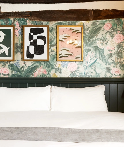 A bed in a hotel room of The Narborough Arms.