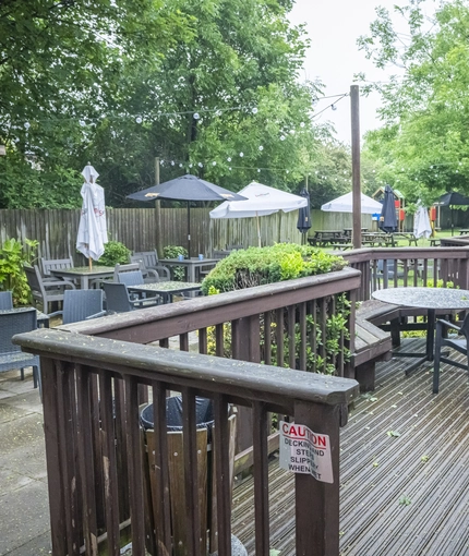 Exterior beer garden of a pub with a seating area.