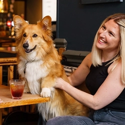 A person sat with a dog