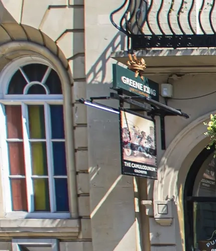External view of a pub entrance and outdoor seating area