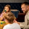 A family sat at an indoor table enjoying a meal and drinks at a Hungry Horse venue.