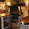 Interior dining area of a pub with a fireplace.