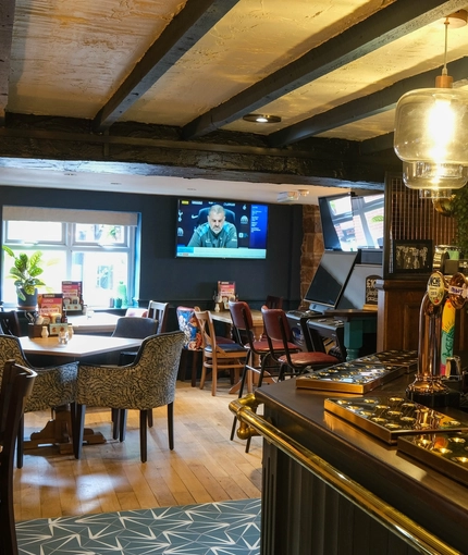 An interior shot of the bar, seating area & TV at the Sitwell Arms in Whiston.