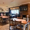 Interior dining area of a pub with a TV and a fireplace.