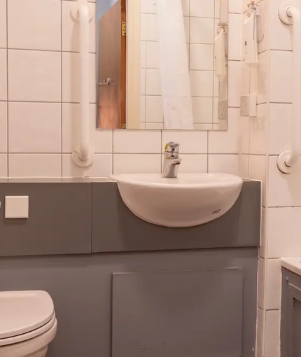 The interior bathroom with sink, bath and toilet at the Kingstown Hotel.