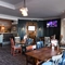 Interior dining area of a pub with a TV.