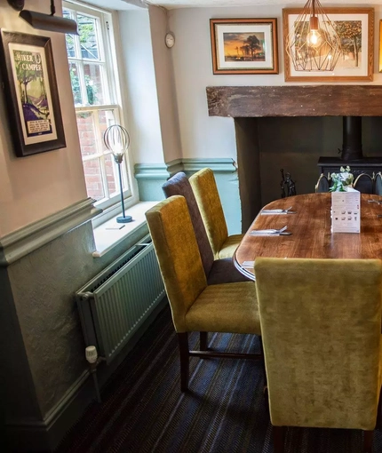interior dining area of a pub with a fireplace