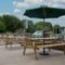 The exterior patio beer garden seating area with wooden benches at The Farmhouse Kitchen Willington.