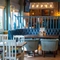 The interior restaurant seating area at The Man On The Moon, with upholstered booth seating, wooden tables and TVs on the walls.