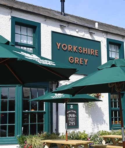The exterior facade and beer garden seating area at The Yorkshire Grey.