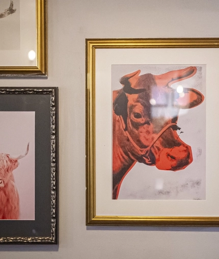 The interior decor comprising of five framed prints hanging on the wall  at The Bull.