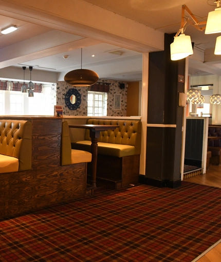 Interior dining area of a pub with a TV.