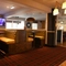 Interior dining area of a pub with a TV.